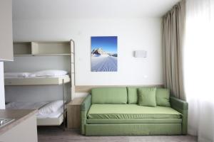 a living room with a couch and bunk beds at Appartamenti Pradalago Marilleva 900 in Marilleva