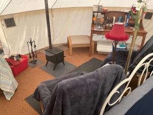 a room with a tent with a table and chairs at Garden County Glamping in Newtown Mount Kennedy