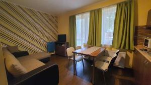 a living room with a couch and a table at Apartment in Siofok - Balaton 19745 in Balatonszabadi Fürdőtelep
