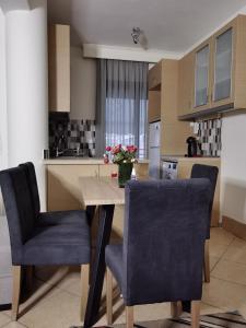 a kitchen with a table and two chairs with flowers on it at Villa Gallen in Limenas