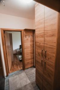 a room with wooden cabinets and a mirror at Apartmani Zračak in Zlatibor +7 photos