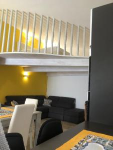 a living room with a black couch and a staircase at Dependance Oscar in Carrozziere +65 photos