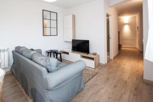 a living room with a couch and a flat screen tv at La Meruxa, adosado a 2 km de la playa VV-2244-AS in Llanes