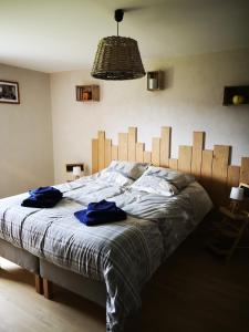 a bedroom with a bed with two blue towels on it at chambre d'hôtes nos racines (chez Muriel et Philippe) in Saulxures-sur-Moselotte