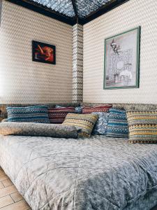 a bedroom with a large bed with colorful pillows at AL BARAKA in Borovoye