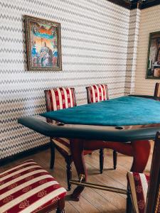 a ping pong table in a room with chairs at AL BARAKA in Borovoye +68 photos