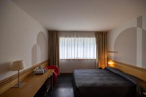 Postel nebo postele na pokoji v ubytování Hotel Europa Belluno