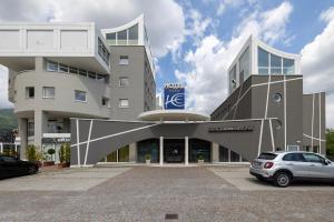 a building with a car parked in front of it at Hotel Europa Belluno in Belluno