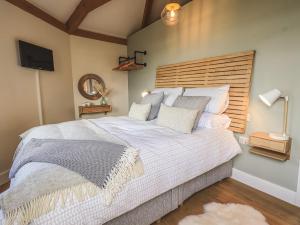 A bed or beds in a room at Oversands Cottage