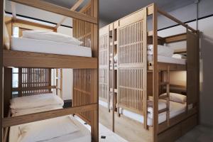 a room with four bunk beds in a room at When in Athens Hostel in Athens