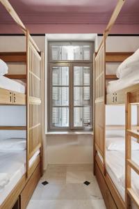 A bed or beds in a room at When in Athens Hostel