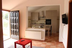a kitchen with a table and a dining room at L'ulivo e lo scoiattolo in Marina Palmense