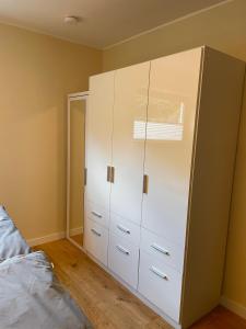 a bedroom with a white cabinet and a bed at Ferienwohnung Fröschenpuhl NEU in Traben-Trarbach