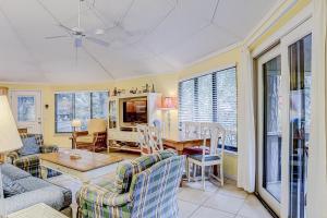 a living room with a couch and a table at Night Heron 35 in Hilton Head Island