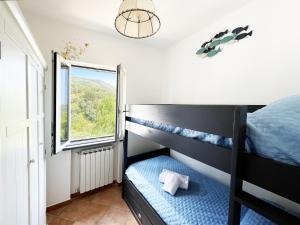 a bedroom with a bunk bed and a window at villa olimpia in Nerano