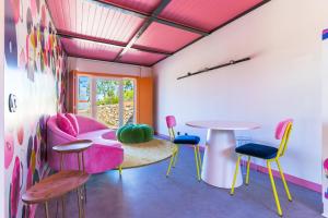 a room with colorful chairs and a table at Moinho d'Antoninha in Leomil