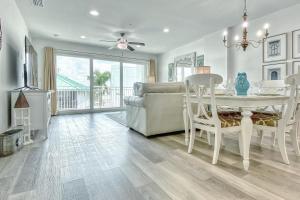 a dining room with a table and a couch at Madeira del Mar 303 in St Pete Beach