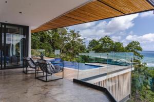 a house with a view of the ocean at Casa Nina Santa Teresa in Santa Teresa Beach