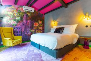 a bedroom with a bed and a yellow chair at Moinho d'Antoninha in Leomil +95 photos
