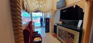 a room with chairs and a tv and a mirror at Hôtel La Citta Rossa in Marrakesh