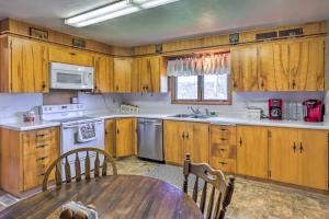 a kitchen with wooden cabinets and a wooden table at Classic Mountain Home, Half Mi to Main Street in Lead