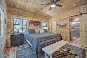 a bedroom with a bed in a wooden cabin at Lakewood Secret Cabin about 4 Mi to The Lake! in Canyon Lake