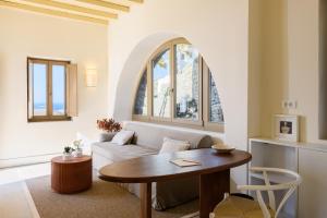 a living room with a table and a couch at Camarades Mykonos in Ano Mera