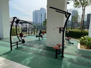 a row of exercise equipment on the roof of a building at Closeup Pool View Romantic Couples Holiday 12 in Cyberjaya
