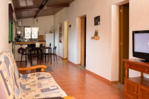 a living room with a couch and a television at La Vuelta del Amo in Las Palmas de Gran Canaria