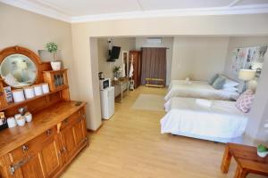 a large room with two beds and a mirror at Boutique Guesthouse Mariental in Mariental
