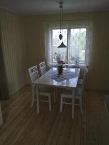 a dining room with a table and chairs and a window at Lodge åstön in Söråker
