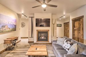 a living room with a couch and a fireplace at Cozy Columbia Falls Condo with Private Balcony! in Columbia Falls