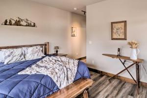 a bedroom with a bed and a wooden table at Cozy Columbia Falls Condo with Private Balcony! in Columbia Falls