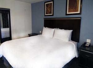 a large white bed in a hotel room at SureStay Hotel by Best Western Chula Vista San Diego Bay in Chula Vista