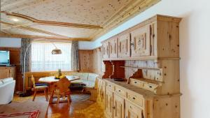 a kitchen with wooden cabinets and a table in a room at Paravicini 1 in St. Moritz +11 photos