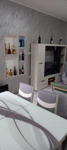 a living room with a table and chairs and a tv at LJiljana 2 Bela crkva in Bela Crkva