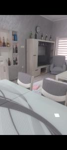 a living room with couches and a tv in a room at LJiljana 2 Bela crkva in Bela Crkva