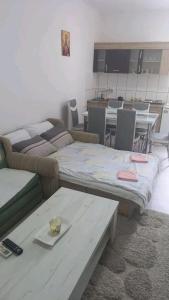 a living room with two beds and a table at LJiljana 2 Bela crkva in Bela Crkva