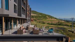 people sitting in chairs on a balcony of a building at Park City Slope Side - Canyons in Park City