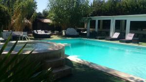 a swimming pool in a yard with chairs at Villa More in Monteroni di Lecce