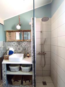a bathroom with a sink and a shower at Habezeiko - The Vintage House in Afitos