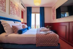 Postel nebo postele na pokoji v ubytování Hôtel Petit Palais