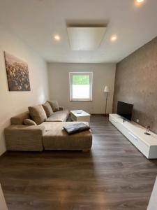 a living room with a couch and a television at Ferienwohnung Gladbeck in Gladbeck