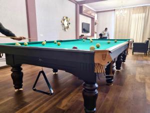 a pool table with balls on it in a room at Laguna Beach Club Bazaleti Lake in Dushetʼi