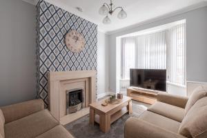 a living room with a fireplace and a tv at Kingsway Property in Goole