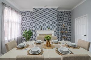 a dining room with a table and chairs and a fireplace at Kingsway Property in Goole