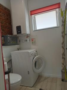 a bathroom with a washing machine and a window at Gite de PHAM in Belberaud +14 photos