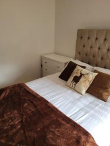 a bedroom with a bed with two pillows on it at Kew House in London