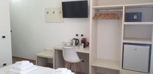 a white room with a table and a chair at Le Camere di Libero e Roberta in Tropea