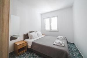Postel nebo postele na pokoji v ubytování Apartments Memidz